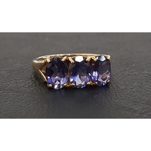 72 - TANZANITE AND DIAMOND RING
the three oval cut tanzanites in pierced setting with diamonds to the sid... 