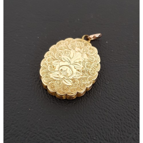 57 - UNMARKED GOLD LOCKET PENDANT
with engraved decoration overall, scalloped edge detail and applied ros... 