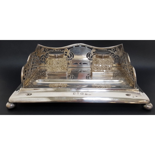 172 - EDWARD VII SILVER DESK STAND
with a shaped and pierced three quarter gallery, with two glass hobnail... 