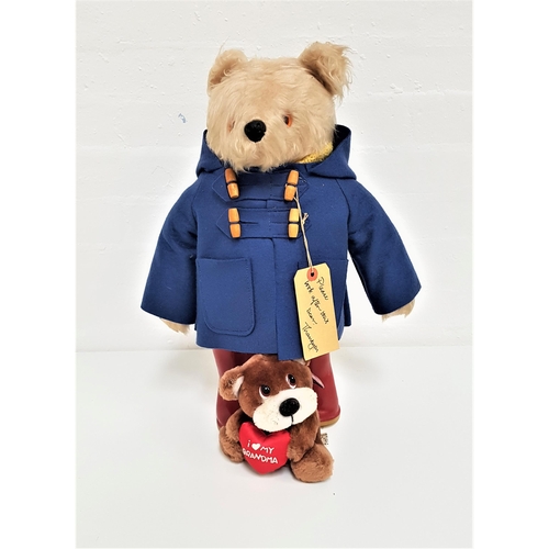 311 - PADDINGTON BEAR
wearing a blue duffle coat, knitted yellow jumper and red wellington boots, 47cm hig... 