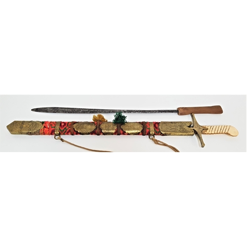 372 - INDIAN STYLE SWORD
with a 64.5cm blade with engraved decoration and a brass offset hilt with a bone ... 