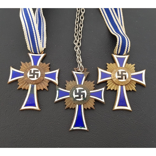 356 - THREE WWII NAZI GERMAN CROSS OF HONOUR OF THE GERMAN MOTHER DECORATION
in brass with blue and white ... 