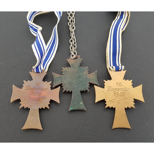 356 - THREE WWII NAZI GERMAN CROSS OF HONOUR OF THE GERMAN MOTHER DECORATION
in brass with blue and white ... 