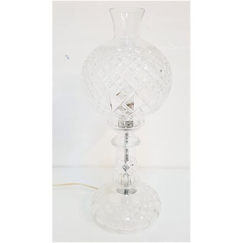 509 - CUT GLASS TABLE LAMP
with a circular shade on a shaped tapering body, 50cm high