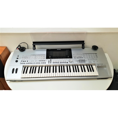 292 - YAMAHA TYROS DIGITAL WORKSTATION KEYBOARD
with a silver finish, shaped perspex music stand, instruct... 