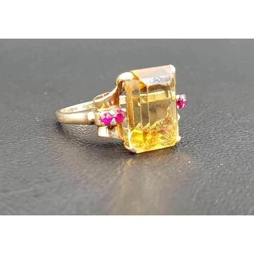 28 - CITRINE AND RUBY DRESS RING
the large central emerald cut citrine measuring 13.5mm x 10mm x 6.35mm, ... 