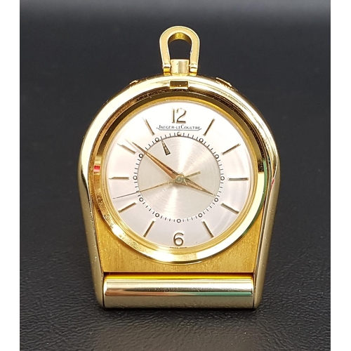 98 - JAEGER-LeCOULTRE GILT METAL FOLDING TRAVEL ALARM CLOCK
the dial with Arabic 12 and 6 together with b... 