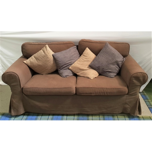 498 - TWO SEAT SOFA
with a fitted loose brown cover and loose seat and back cushions, with four scatter cu... 