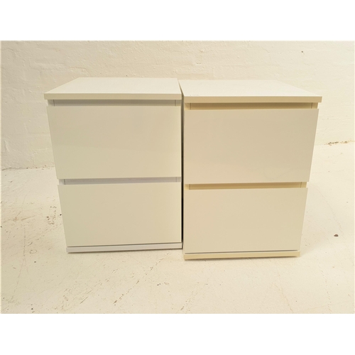 506 - PAIR OF GLOSS WHITE SIDE CABINETS
each with two drawers, standing on cap feet, 55cm high (2)