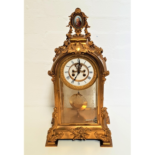 513 - 19th CENTURY FRENCH ORMOLU MANTLE CLOCK
of arched form and surmounted with an oval porcelain plaque ... 