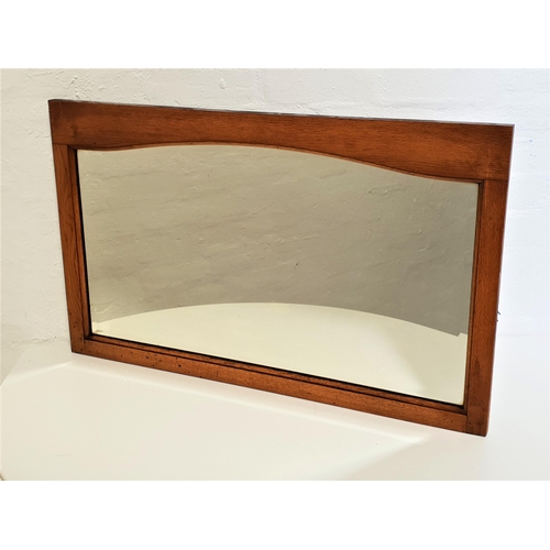 520 - RECTANGULAR OAK FRAME WALL MIRROR
with a shaped bevelled plate, 84cm wide