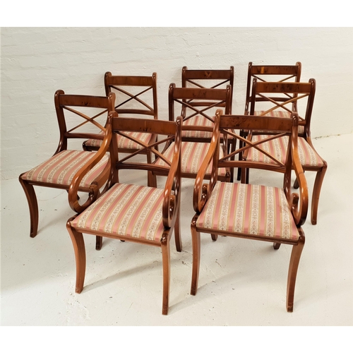 527 - SET OF EIGHT YEW DINING CHAIRS
each with an X frame back above a stuffover seat, standing on sabre f... 