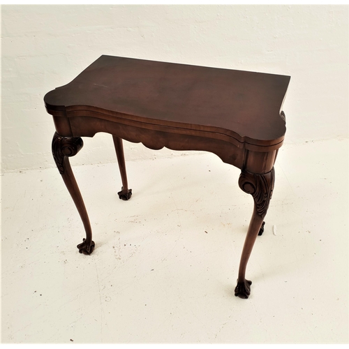 539 - SHAPED WALNUT CARD TABLE
with a rotating fold over baize lined top, standing on cabriole supports wi... 