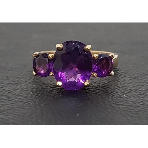 104 - GRADUATED AMETHYST THREE STONE RING
the central oval cut amethyst approximately 2.5cts flanked by ro... 