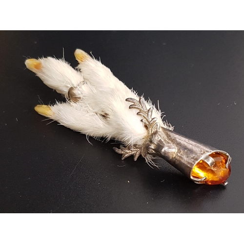 115 - GROUSE FOOT BROOCH
the silver plated mount decorated with stag head and set with amber coloured glas... 