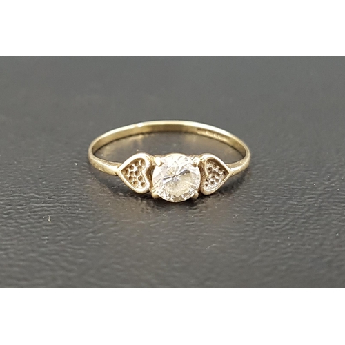 150 - CLEAR GEM SET DRESS RING
the central gemstone flanked by textured hearts, on nine carat gold shank, ... 