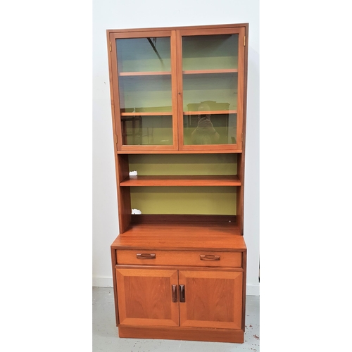 1772 - G PLAN TEAK WALL UNIT
with a pair of glass doors opening to reveal shelves above an adjustable shelf... 