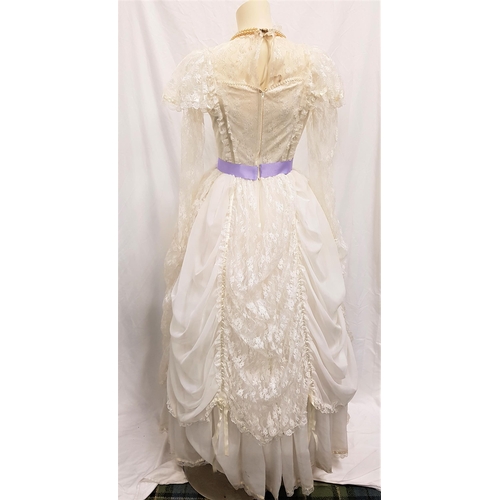 93 - IVORY BALLGOWN - UNKNOWN PRODUCTION 
the dress with lace and purple ribbon detail, with layered skir... 