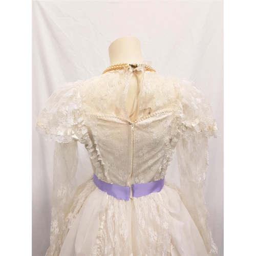 93 - IVORY BALLGOWN - UNKNOWN PRODUCTION 
the dress with lace and purple ribbon detail, with layered skir... 