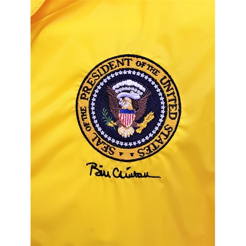 136 - BILL CLINTON - YELLOW RUNNING JACKET
embroidered with his name and the Presidential Seal. Accompanie... 