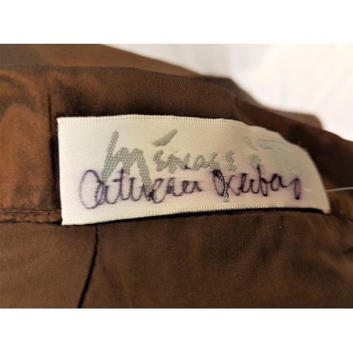 149 - CATHERINE OXENBERG - TWO PIECE COPPER COLOURED OUTFIT
by Menage a Trois, signed to label of skirt. A... 