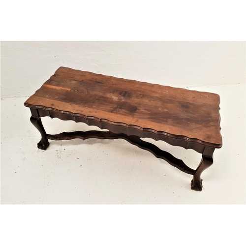 386 - TEAK OCCASIONAL TABLE
the oblong top with a wavy edge and frieze, standing on cabriole supports with... 