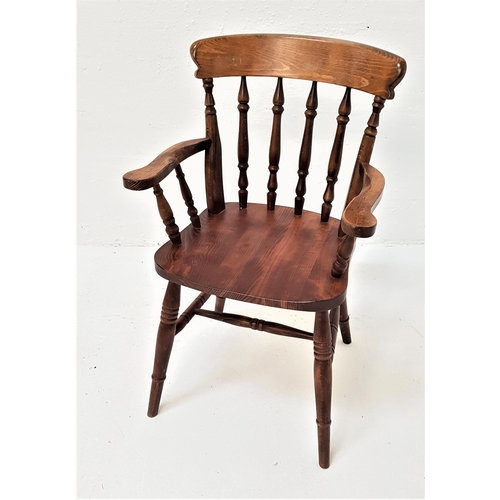 387 - ASH AND ELM WINDSOR TYPE ARMCHAIR
with a shaped top rail above six turned columns and outswept arms,... 