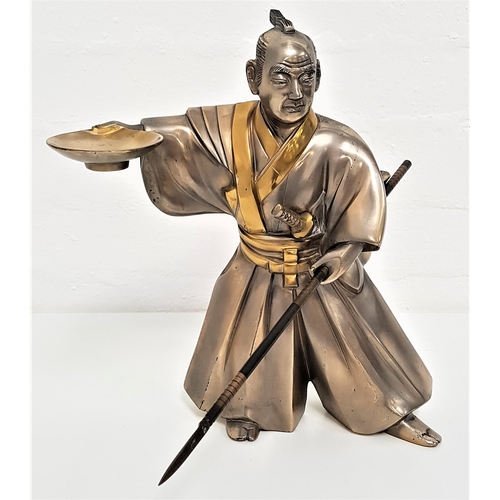 229 - JAPANESE STAINLESS STEEL FIGURE OF A SAMURAI
wearing a kimono and holding a bowl in his raised right... 