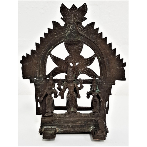 240 - INDIAN BRONZE SHRINE
with an arched top above Shiva, flanked by attendants on an oblong stepped base... 