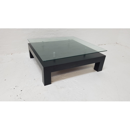 367 - CONTEMPORARY OCCASIONAL TABLE
with a floating square glass top above a stained black wood base, on s... 