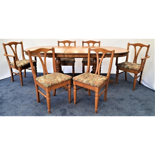 381 - DUCAL VICTORIA PINE EXTENDING DINING TABLE AND CHAIRS
the table with pull apart D ends revealing a f... 