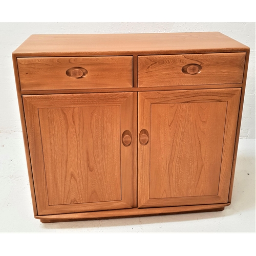 432 - ERCOL LIGHT OAK SIDE CABINET
with a moulded top above two frieze drawers with a pair of panelled cup... 