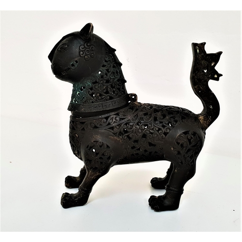 262 - HOLLOW CAST BRONZE INCENSE BURNER
of a standing cat with pierced scroll decoration overall and a hin... 