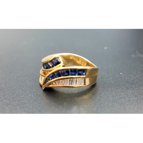 108 - ATTRACTIVE DIAMOND AND SAPPHIRE CROSSOVER RING
with channel set baguette cut diamonds and cabochon s... 