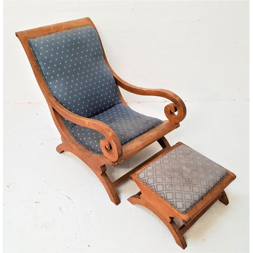 411 - MID 20th CENTURY TEAK ARMCHAIR
with a padded back and seat and elaborate scroll arms, standing on sh... 