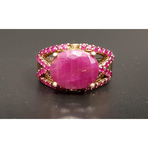 73 - RUBY DRESS RING
the large central oval cut ruby approximately 4.5cts in ruby set pierced setting, on... 