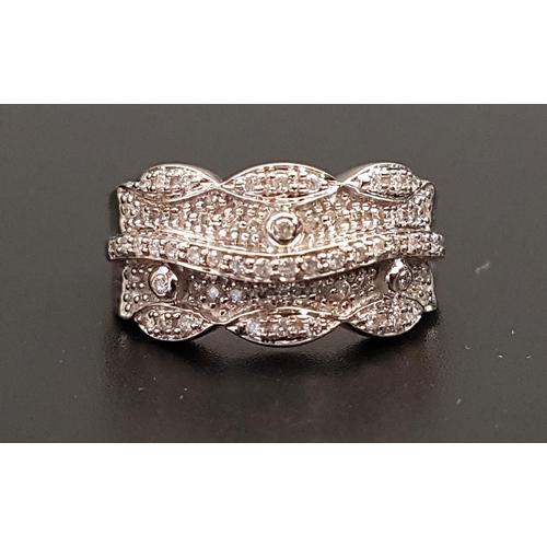 74 - DIAMOND SET DRESS RING
the multi diamonds in shaped setting with central raised wavy line of diamond... 