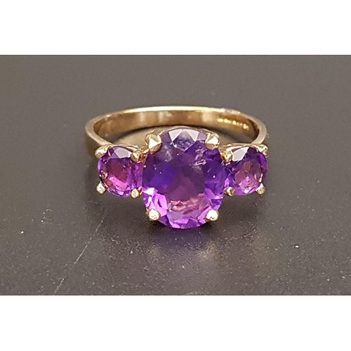 76 - GRADUATED AMETHYST THREE STONE RING
the central oval cut amethyst approximately 2.5cts flanked by ro... 