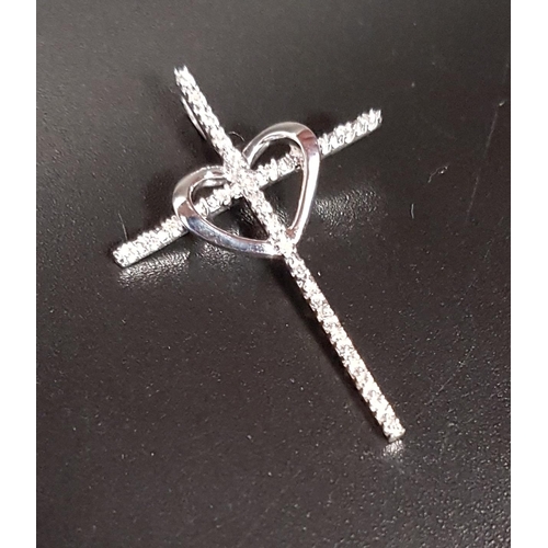 85 - DIAMOND SET CROSS PENDANT
with central heart detail, in unmarked white gold, 3.2cm high