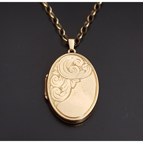 93 - NINE CARAT GOLD OVAL LOCKET PENDANT
with engraved scroll decoration, 3.9cm high including suspension... 