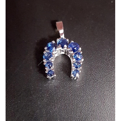 115 - GRADUATED SAPPHIRE SET HORSESHOE PENDANT
in eight carat white gold, marked '333', approximately 1.8c... 