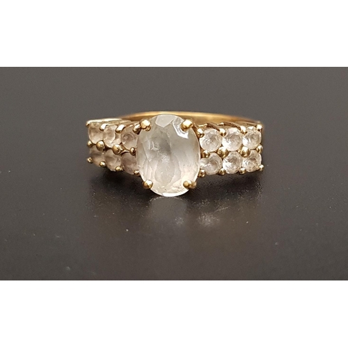 118 - QUARTZ DRESS RING
the central oval cut gemstone flanked by two rows of smaller quartz gemstones, on ... 