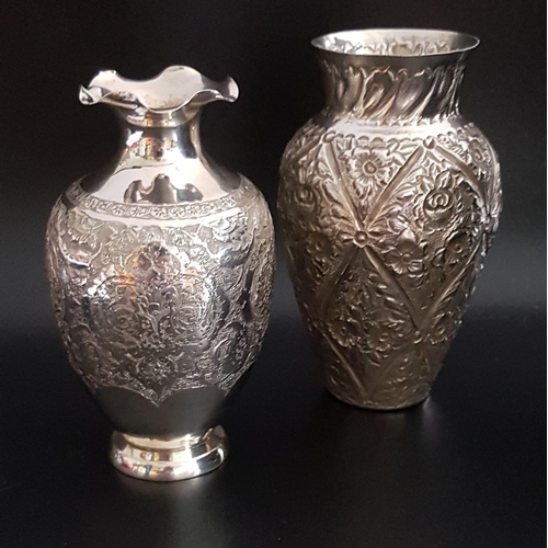 133 - TWO SMALL SILVER FLOWER VASES
the frilly rimmed example with embossed and engraved floral decoration... 