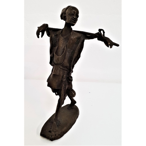 280 - BRONZE AFRICAN FIGURE
of a man carrying his staff over his shoulders while walking, unsigned, 22.5cm... 