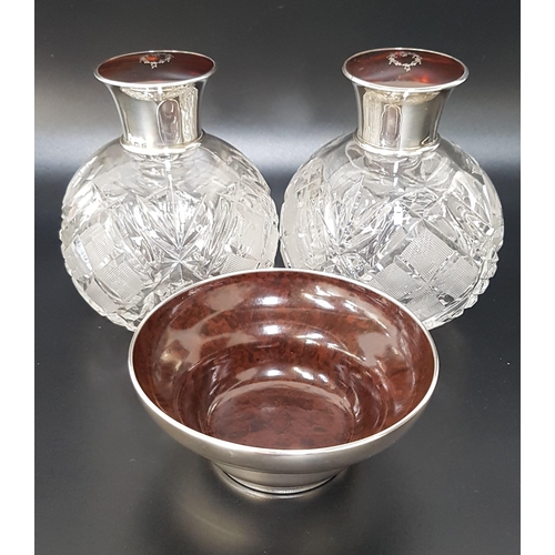 197 - PAIR OF GEORGE V SILVER TOPPED GLASS SCENT BOTTLES
with inset tortoise shell to the lids with a silv... 