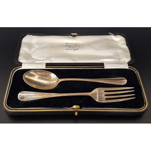 208 - GEORGE V SILVER CHRISTENING SET
comprising a spoon and fork in the rat tail pattern, the terminals m... 