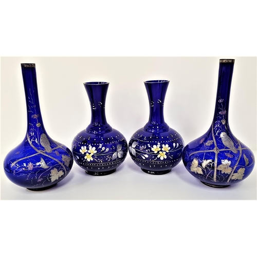 227 - TWO PAIRS OF BRISTOL BLUE STYLE DECANTERS
both pairs over painted with flowers and leaves, one with ... 