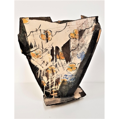 229 - DENNIS FARRELL
a slab sided vase of irregular form with abstract design, on an irregular base, 41cm ... 