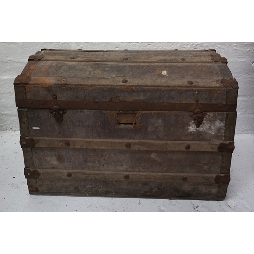 460 - VINTAGE METAL BOUND TRAVEL TRUNK
with domed top and metal carrying handles, 67.7cm wide