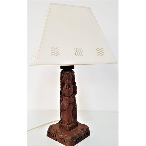 293 - CHINESE CARVED TEAK TABLE LAMP
raised on a square base, the column depicting a man in traditional dr... 